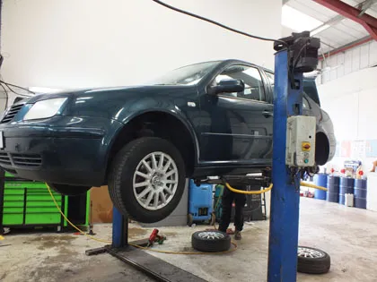 A Volkswagen Golf on the lift in the workshop