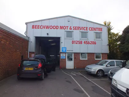 The Beechwood MOT & Service Centre building on Blandford Heights, the sign and the phone number over the workshop door